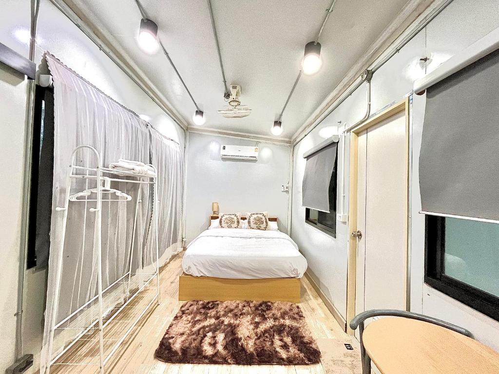 a small room with a bed and a tv at Datok homestay in Ban Khok Tarot