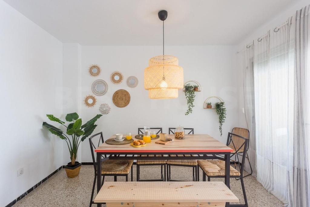 a dining room with a table and chairs at Cozy Apartment in Salinetas Beach. in Salinetas