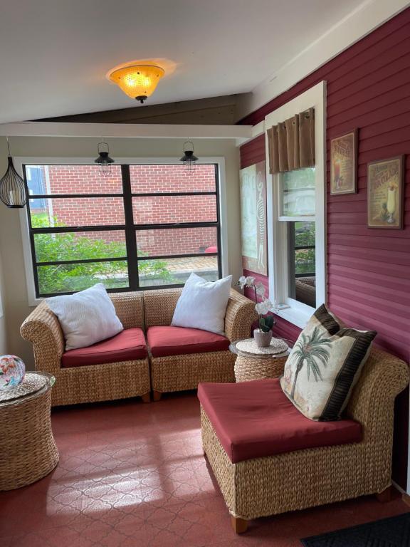 a living room with two couches and two windows at The Lily Pad in Pinckney