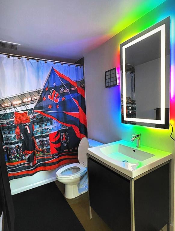 a bathroom with a spiderman shower curtain and a sink at The 513 Loft- 2bdrm, 2bath Loft Only Steps From Paycor Stadium, Fountain Square, & Duke Energy Ctr ! in Cincinnati