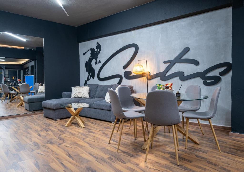 a living room with a couch and a table and chairs at House of Paralympic Athlete Mike Seitis in Rhodes Town