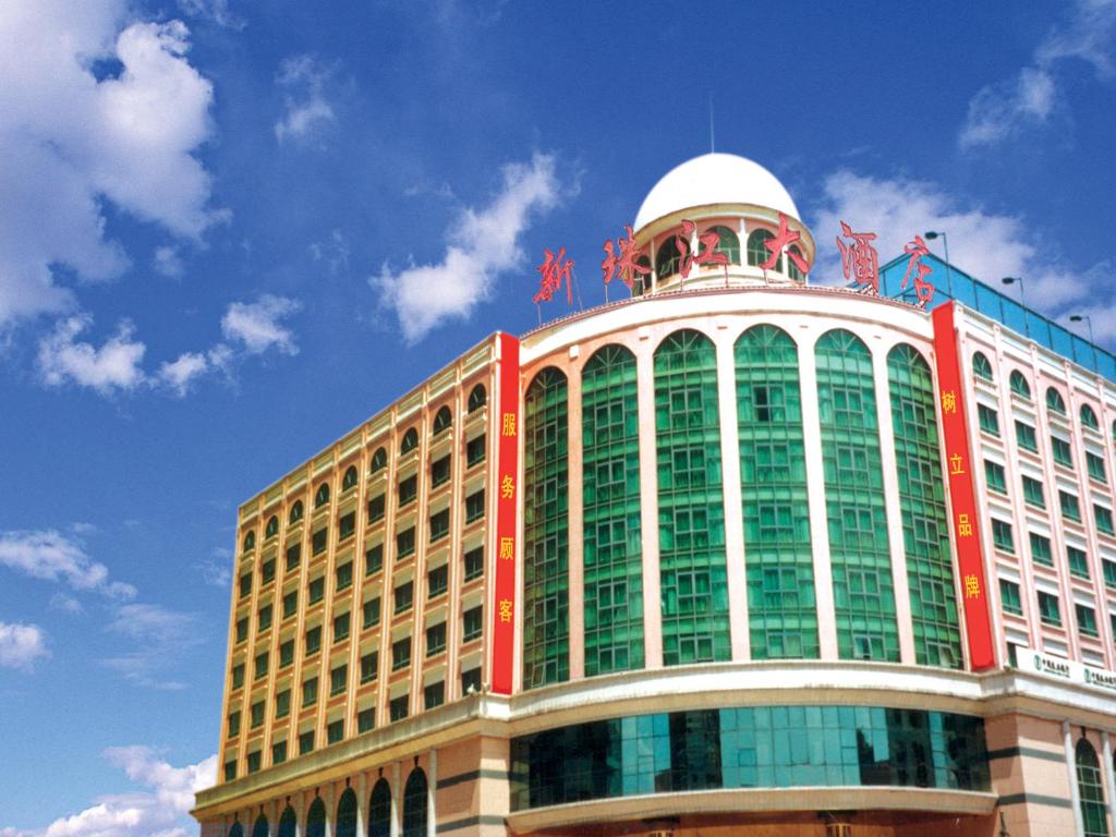 a large building with a red and green at New Pearl River Hotel in Guangzhou