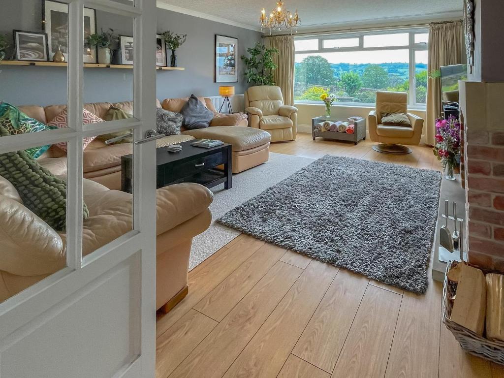 a living room with a couch and a table at Keepsake View in Two Dales