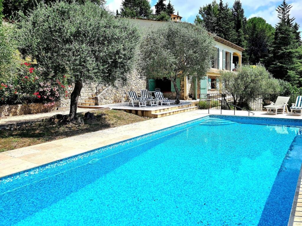 a swimming pool in front of a house at Provence villa with heated pool and amazing view in Montauroux