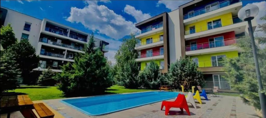 a swimming pool in front of a building at Airport Residence in Otopeni