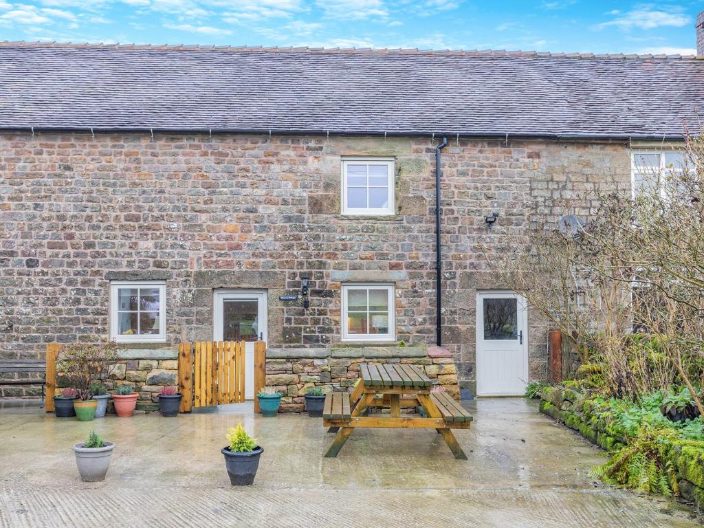 a brick house with a picnic table in front of it at Clarence Cottage - Uk47494 in Waterfall