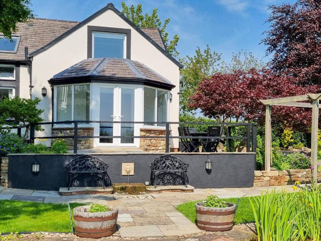 a house with a gazebo in a yard at Beacon Cottage in Ivegill
