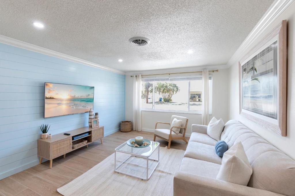 a living room with a couch and a tv at Beach Getaway on Anna Maria Island in Holmes Beach
