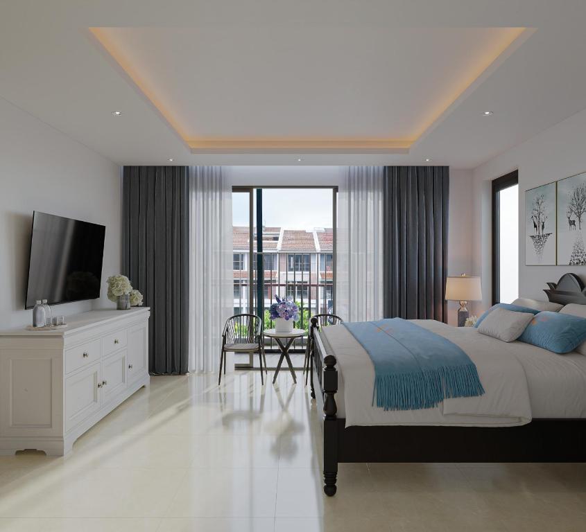 a white bedroom with a large bed and a television at Luna Oriental in Phu Quoc