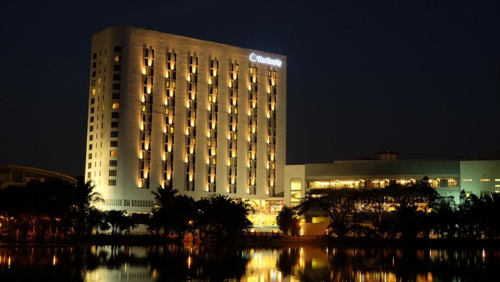 a large building at night with its lights on at The Everly Putrajaya in Putrajaya