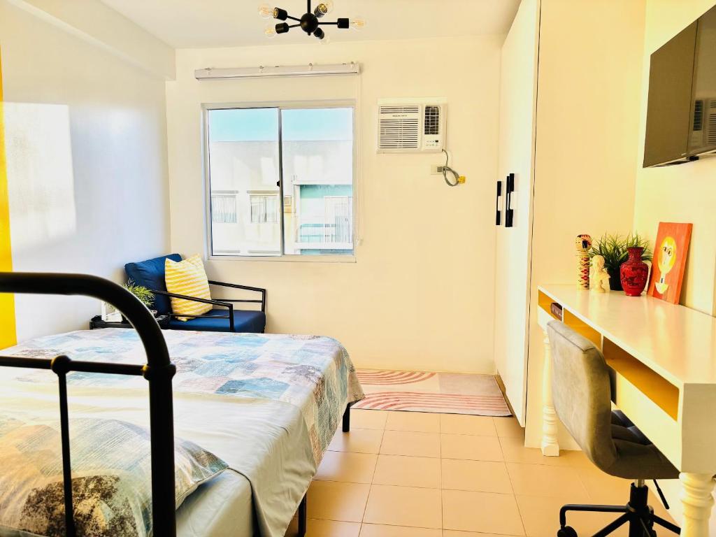 a small room with a bed and a kitchen at Studio By The Sea in Dumaguete