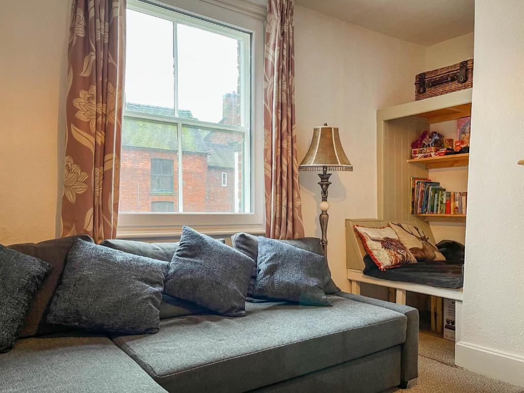 a living room with a couch and a window at Market View in Ashbourne