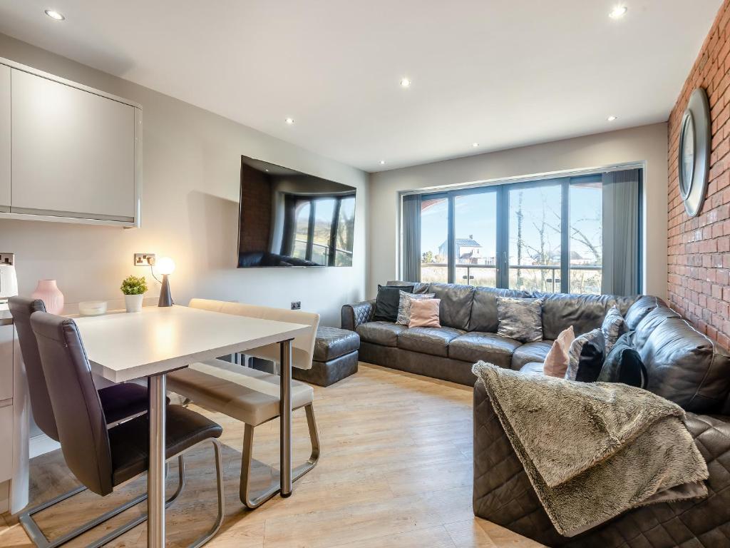 a living room with a couch and a table at The Barn Owl - Uk36217 in Bowness-on-Solway