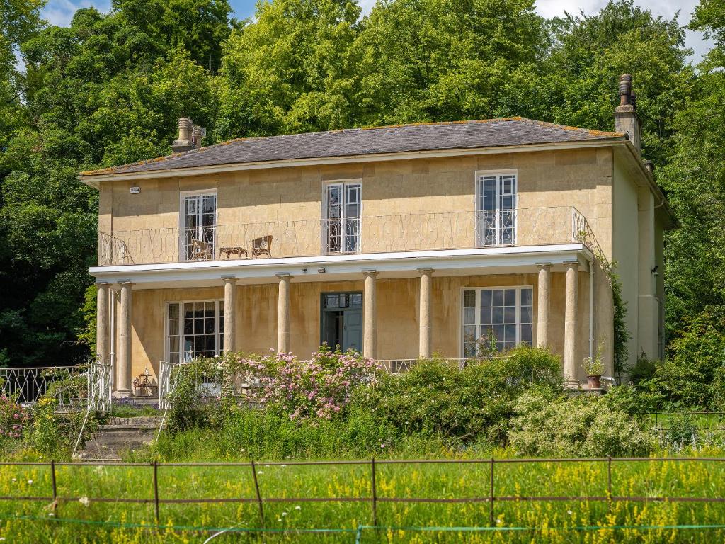 una casa vieja con una valla delante de ella en Henge Estate, en Shrewton