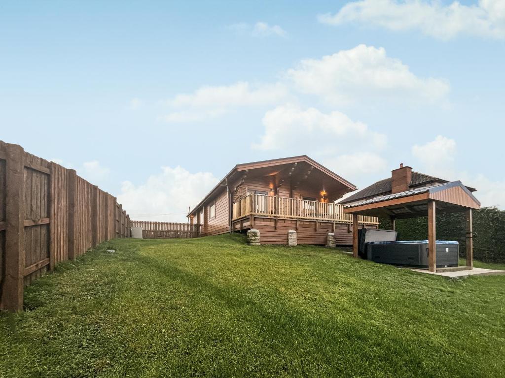 a large yard with a barn and a fence at Coo Lodge - Uk48430 in Falkirk