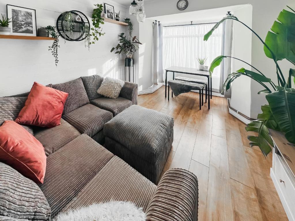 a living room with a couch and a table at The Annex At Tenniside in Perranporth