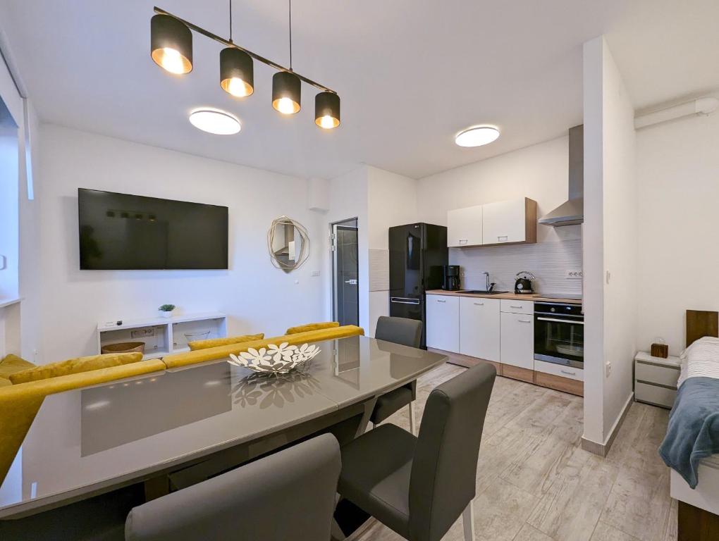 a kitchen and living room with a table and chairs at Funktastic Central Maksimir Condo in Zagreb