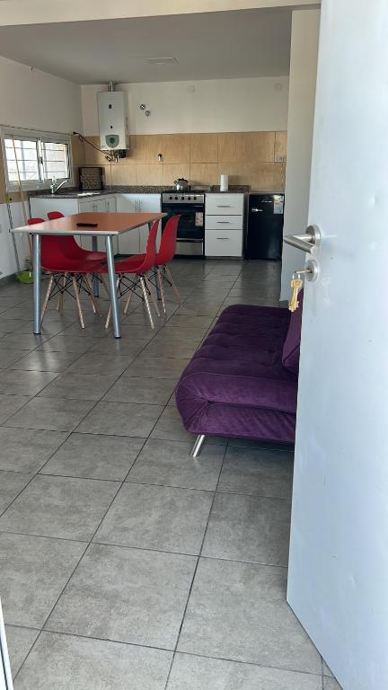 a kitchen with a table and chairs and a couch at Departamentos Casa Pueblo in Villa Mercedes