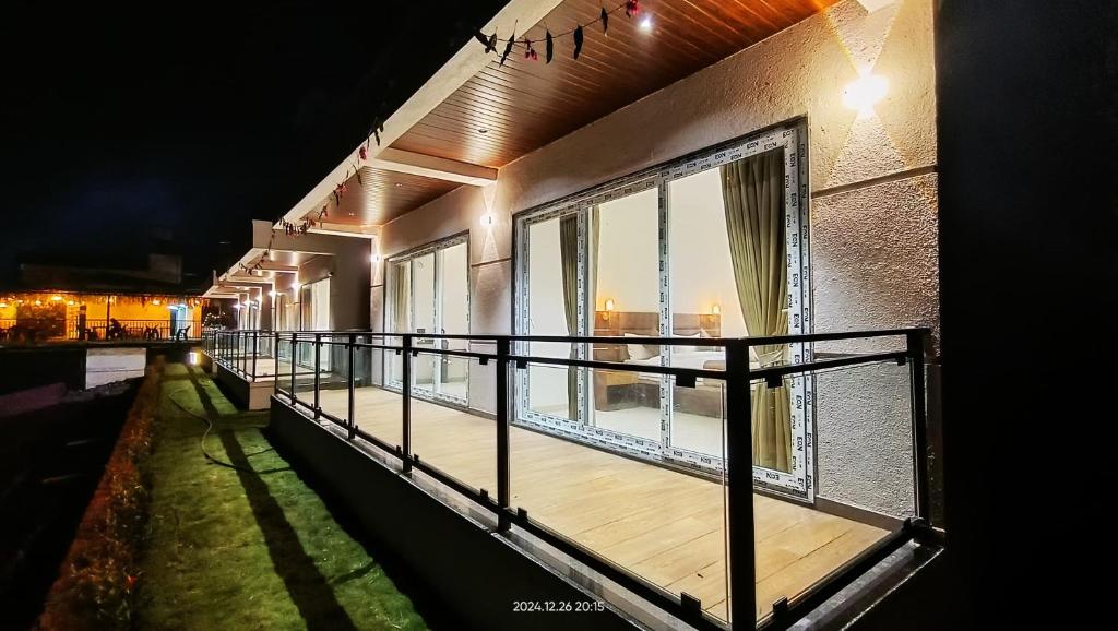 an empty balcony of a building at night at Mountain Berries Resort in Panchgani