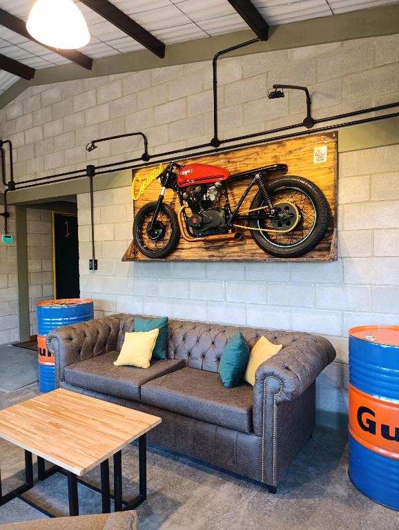 a painting of a motorcycle hanging on a wall at Cyclotel Motoposada in Valle Hermoso