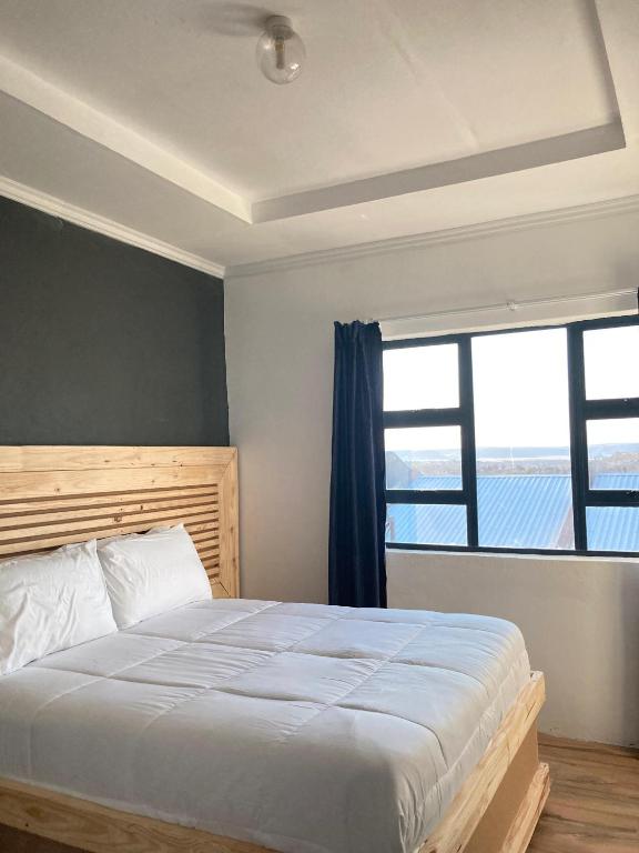 马塞卢Solomon Guest House的一间卧室，配有一张大床和一扇窗户。