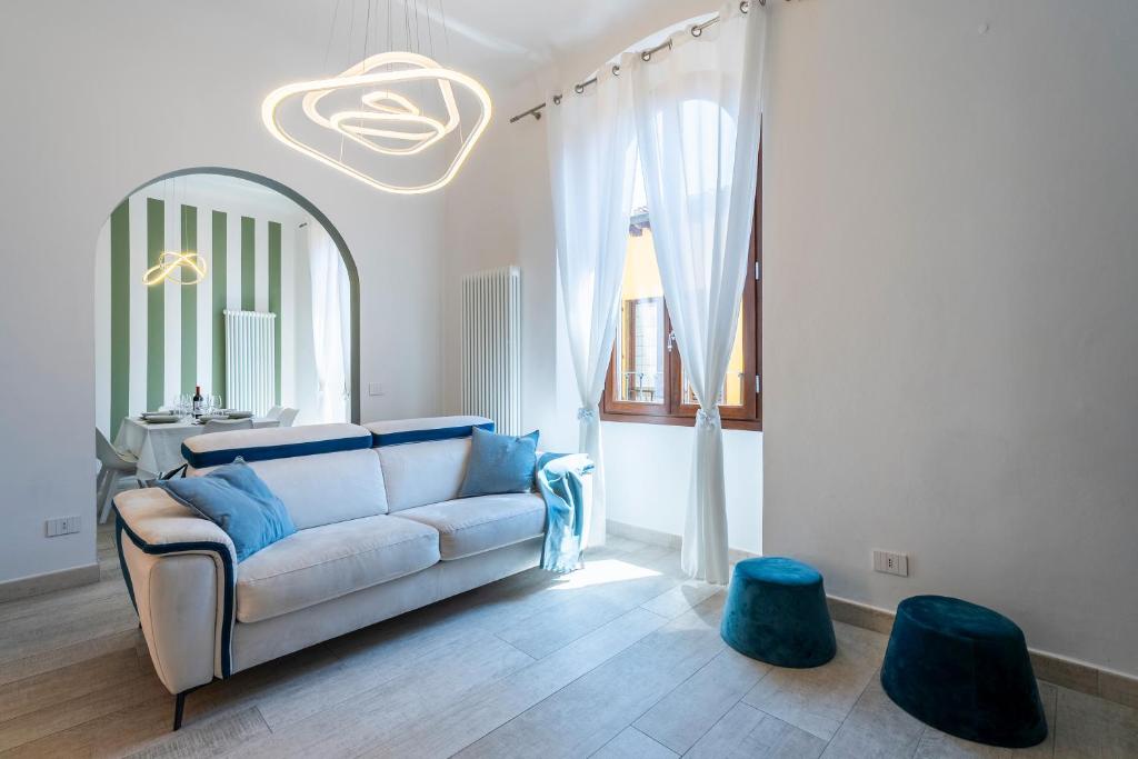 a living room with a couch and two blue stools at La Domus Firenze in Florence