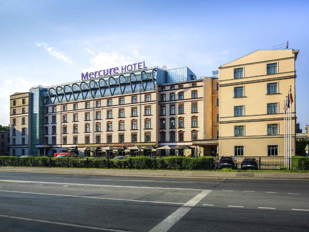 a building with a sign on the top of it at Mercure Riga Centre in Rīga