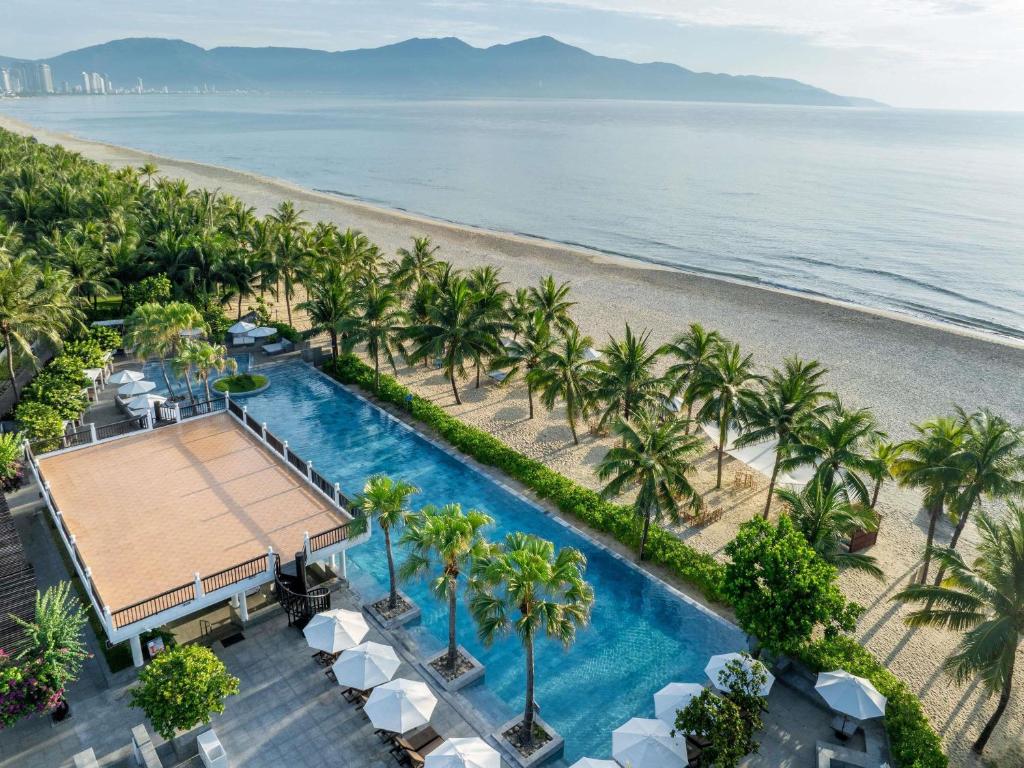 an aerial view of a beach with palm trees and a swimming pool at Premier Village Danang Resort Managed By Accor in Da Nang