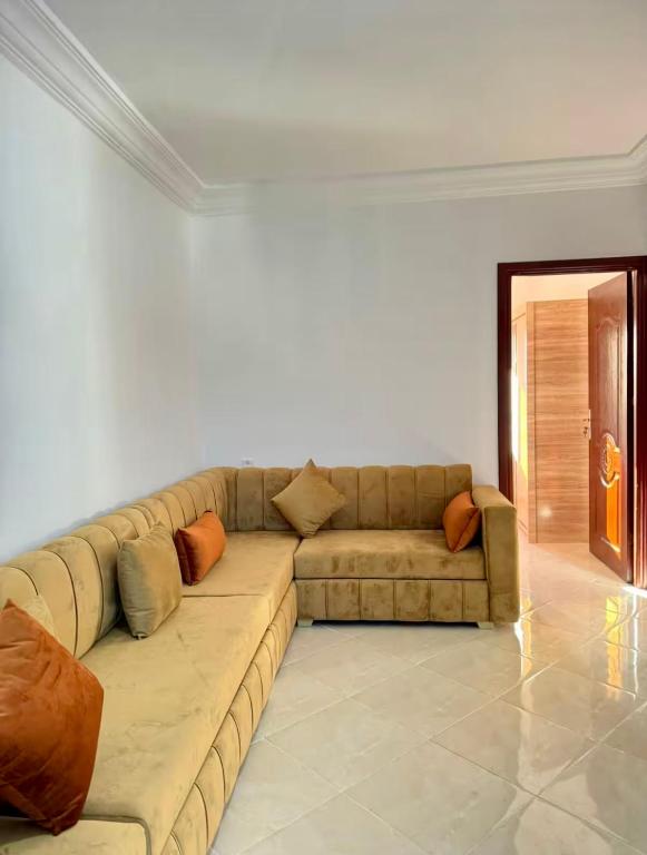 a living room with a large couch in a room at Appartement Neuf Plage Mdiq in M'diq