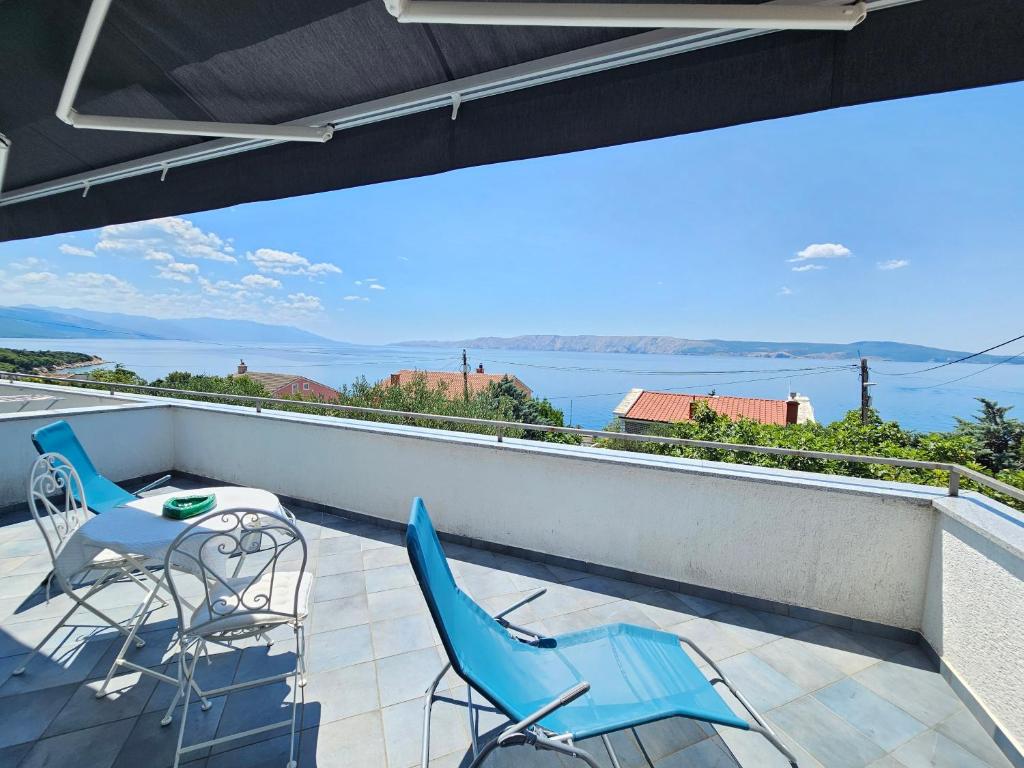 a balcony with two chairs and a table and a view at MIMICA Double ROOM with private bathroom and terrace in Novi Vinodolski