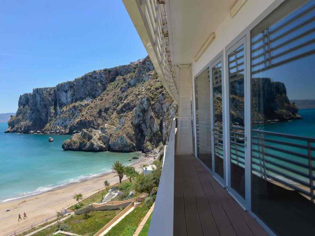 a balcony of a house with a view of the beach at Mercure Quemado Al-Hoceima Resort in Al Hoceïma