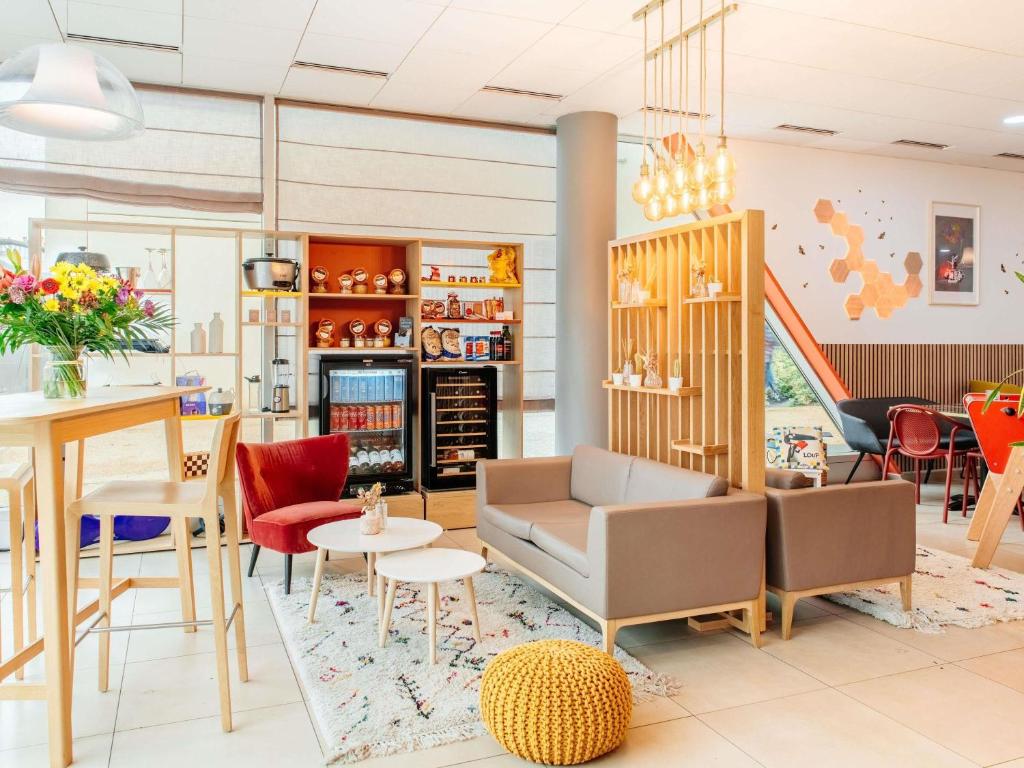a lobby of a store with chairs and tables at Aparthotel Adagio Access Nancy Centre in Nancy