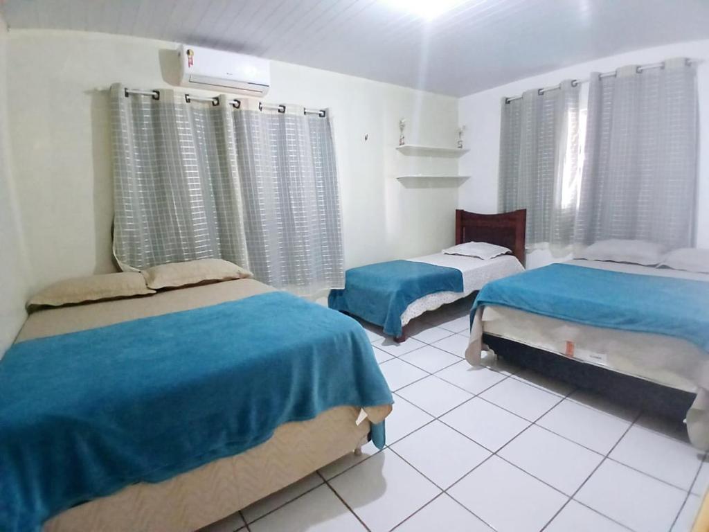 a bedroom with two beds in a room at Furtado Temporada in Santo Amaro