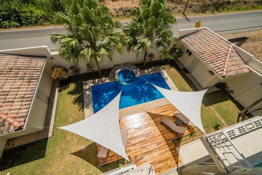 an aerial view of a house with a swimming pool at Beachside 1st Floor Condo Near Flamingo & Conchal in Playa Flamingo