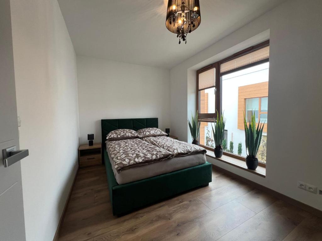 a bedroom with a bed and a large window at Apartament Przystań Nadole in Nadole