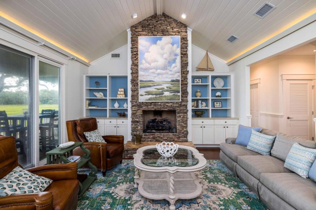 a living room with a couch and a fireplace at 111 Cardinal Crest - Resort Access & Golf Cart Included! in Fripp Island