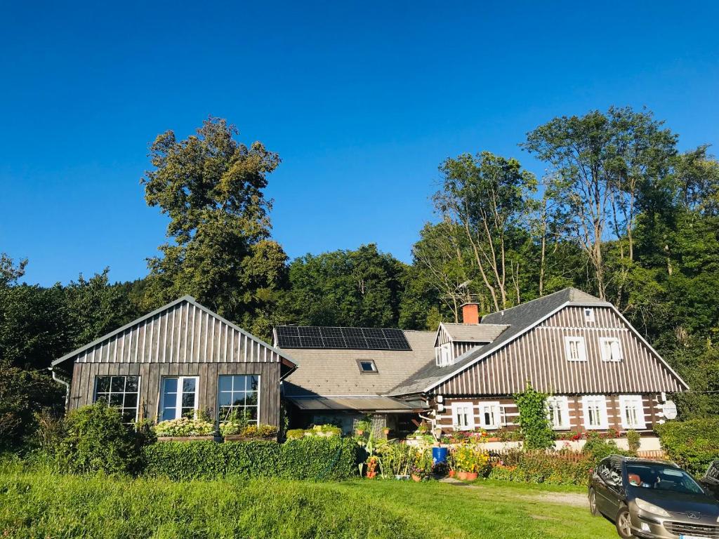 a house with solar panels on the roof at horská chalupa U lyžaře in Benecko