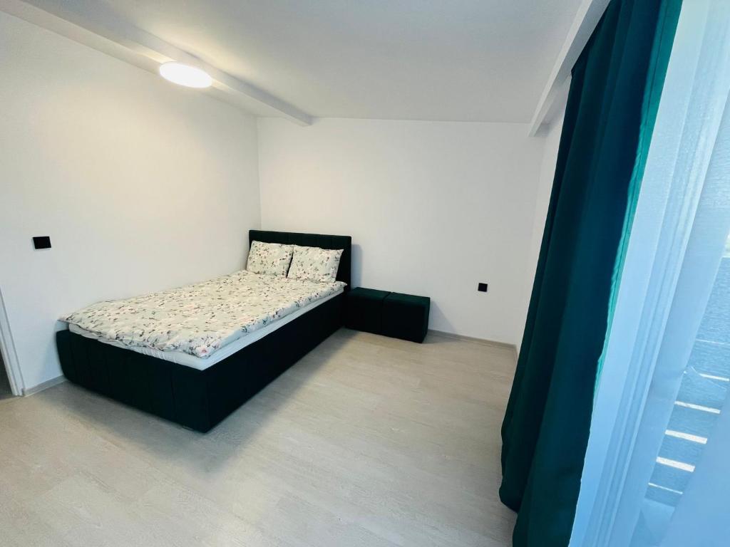 a small bedroom with a bed in a room at Antonia home in Târgu-Mureş