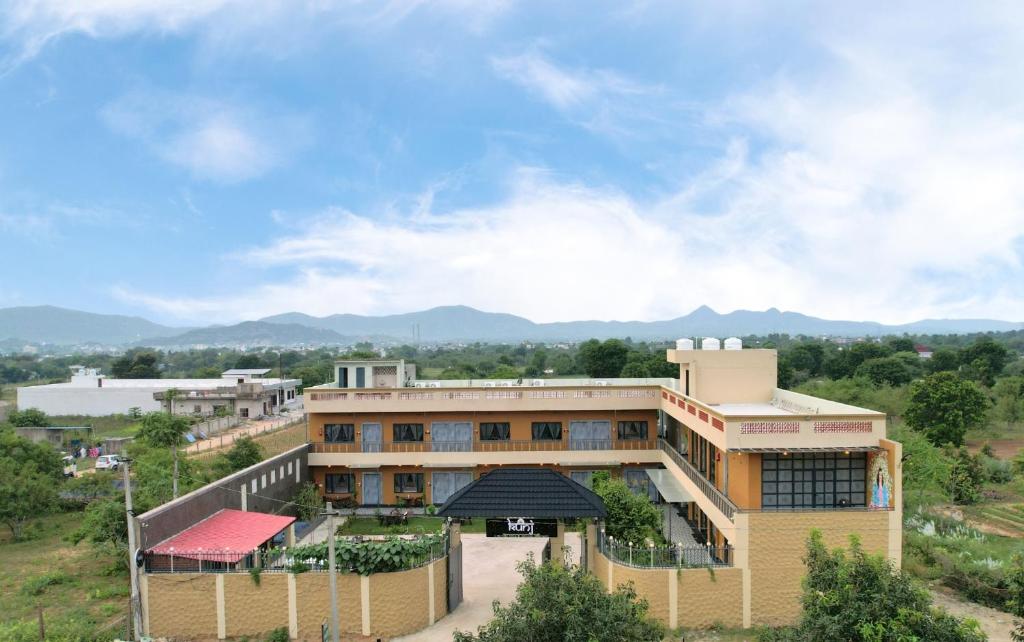 an aerial view of a building with mountains in the background at Kunj - A Boutique Hotel By Shivaneel Hospitality in Pushkar