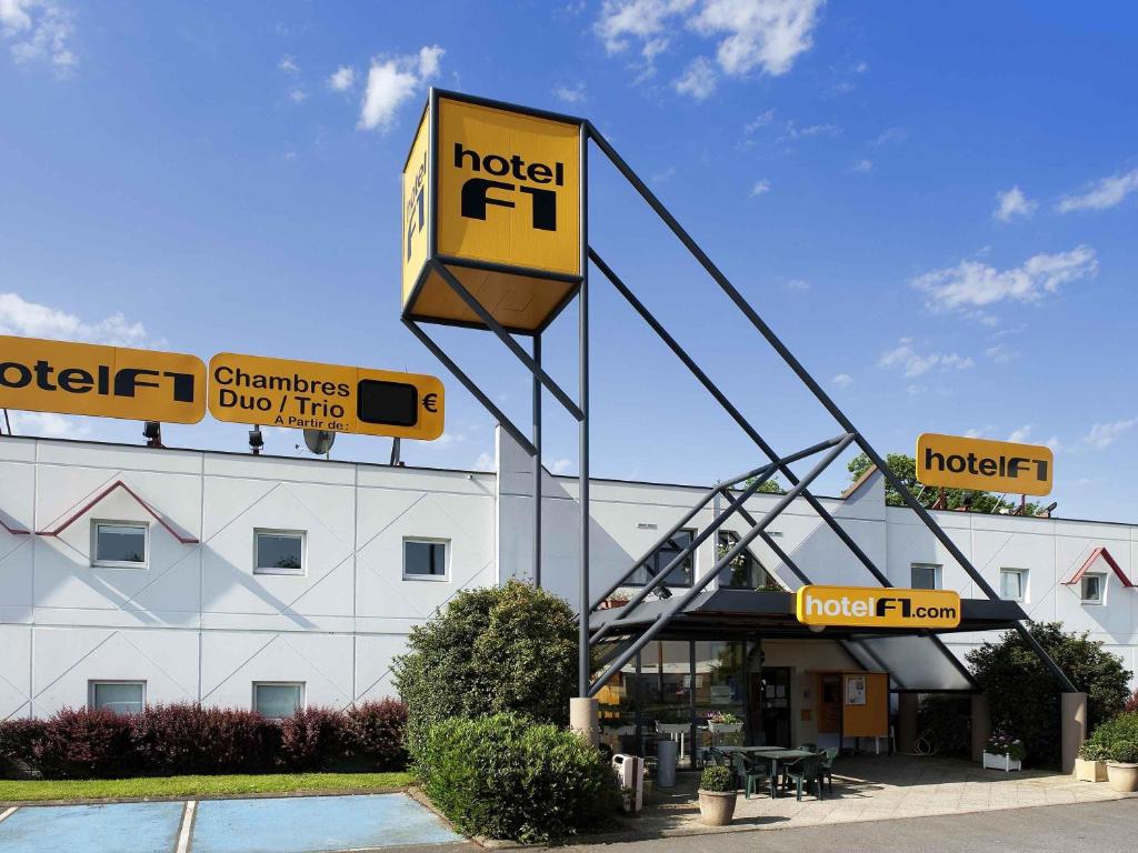 a hotel with a sign in front of a building at hotelF1 Epinal Nord in Épinal