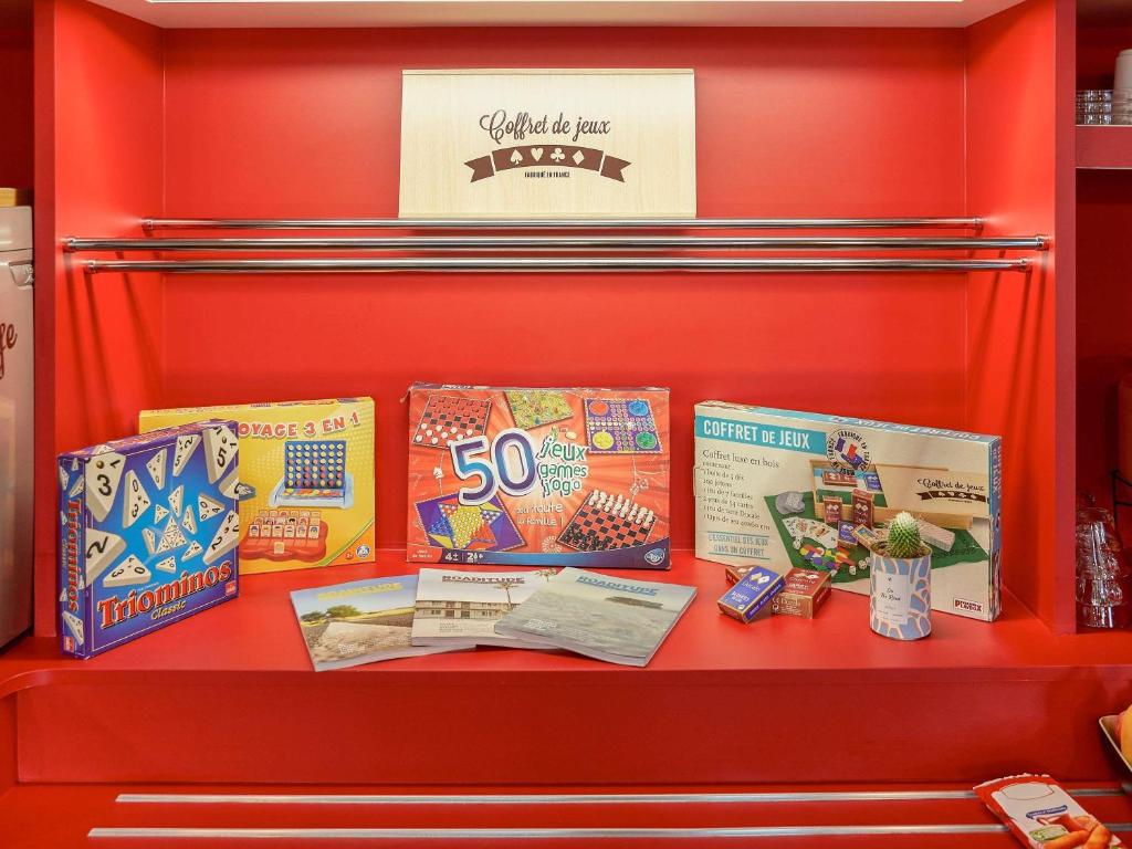 a red shelf with two boxes of candy at hotelF1 Bordeaux Ville in Bordeaux