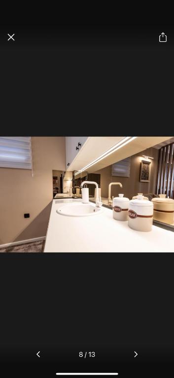 a picture of a bathroom with a sink and toilets at Little star in Ulcinj