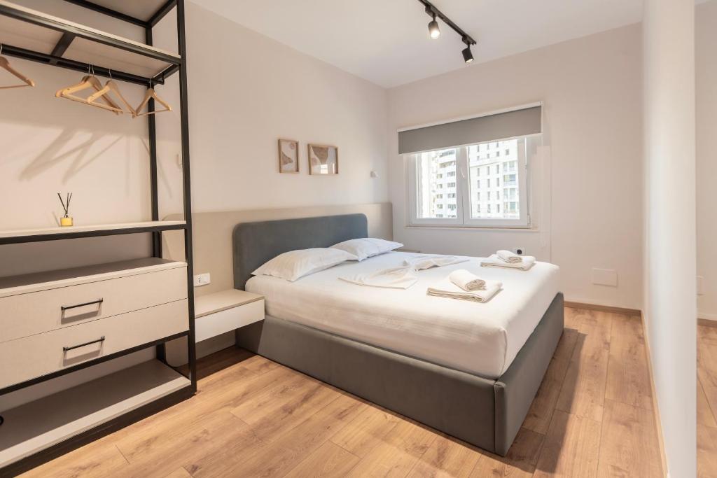 a bedroom with a large bed and a window at 2BR at Artist's Palace - Skanderbeg Square Views in Tirana