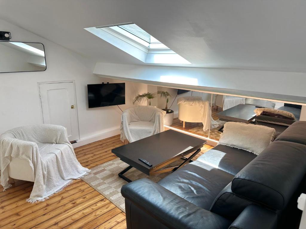 a living room with a couch and a table at Charmant appartement vincennes in Vincennes