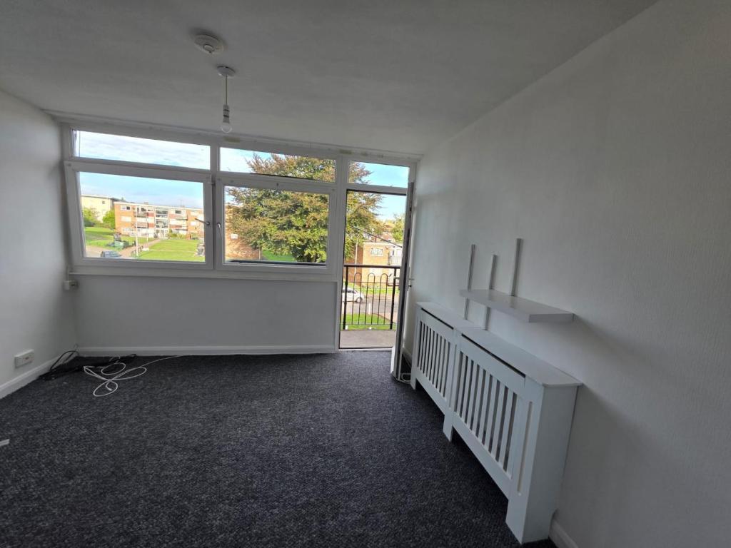 an empty room with a large window and a staircase at Spacious contractors and tourist apartment with parking & Wifi in Wainscot