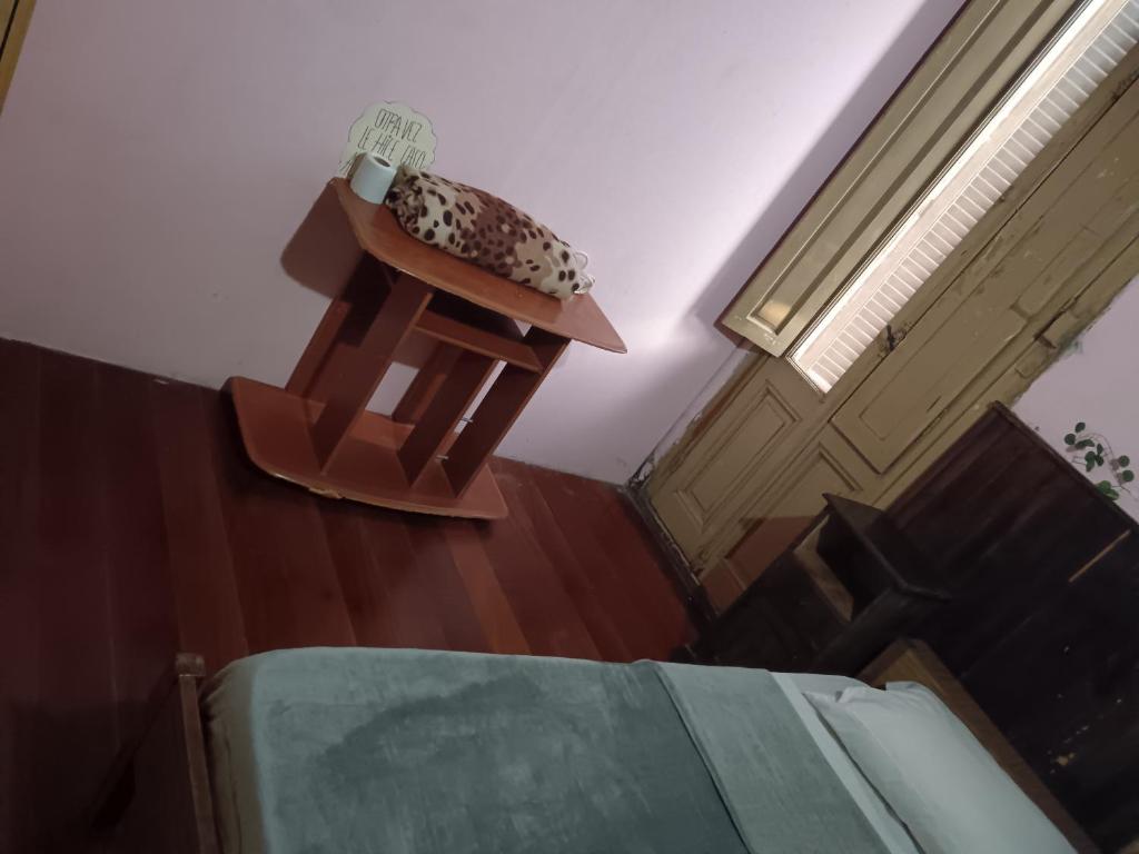 a bedroom with a bed and a table with money on it at Habitación individual Privada Casa compartida in Montevideo