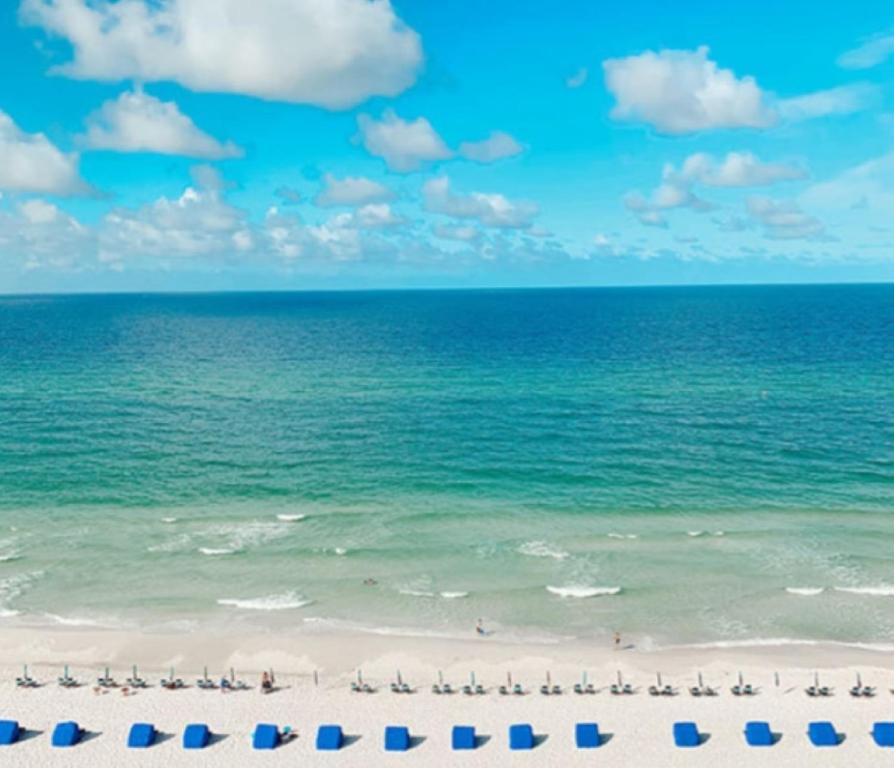 a beach with a group of chairs and the ocean at Great Vibes in Panama City Beach