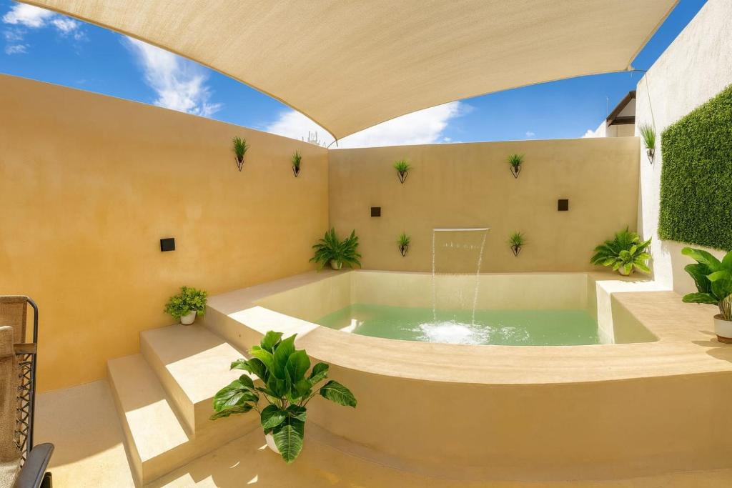a jacuzzi tub in a room with plants at Sáasil Retreat - Connect with yourself in Mérida