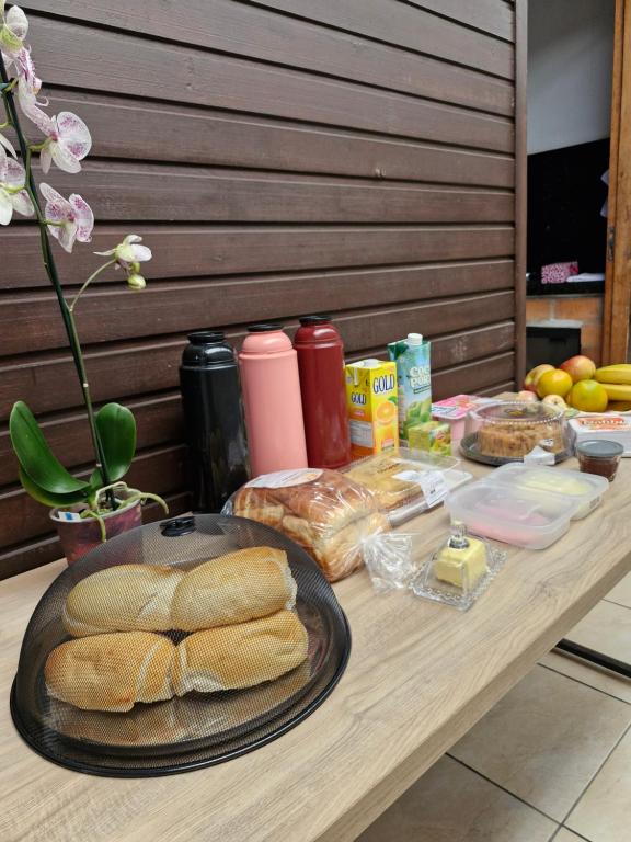 a table with bread and other food on it at Apartamento 3,3km oktoberfest até 2 pessoas com opção de café da manhã in Blumenau