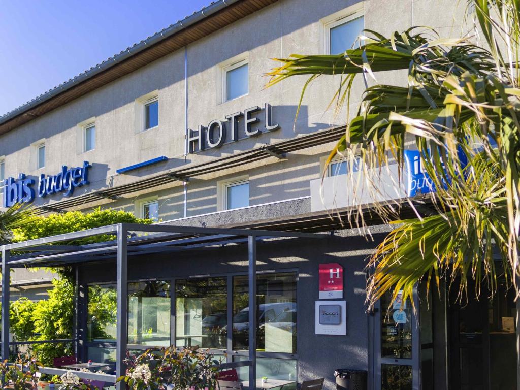 a hotel sign on the front of a building at ibis budget Carcassonne La Cité in Carcassonne